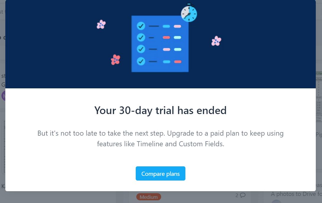Cửa sổ Asana thông báo “Your 30-day trial has ended”, yêu cầu nâng cấp để tiếp tục dùng Timeline và Custom Fields, kèm nút “Compare plans”.
